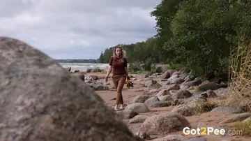 European Blonde Leans Back on a Boulder to Piss on the Beach