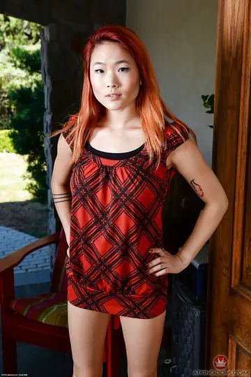 Thick Asian Redhead Bares Her Shaved Pussy and Big Natural Tits