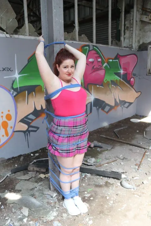 Curvy Redhead MILF Bound to a Post in Her Skirt – photo 16 of 16