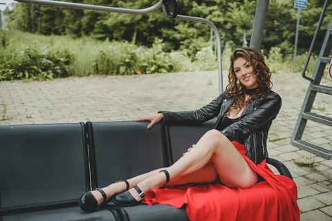 Amateur with Curly Hair Poses Outdoors Flashing Her Legs – photo 6 of 15
