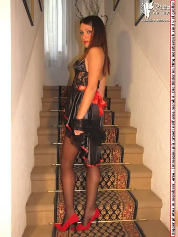 European Woman in a Skirt and Pantyhose Slips Off Her Red Heels