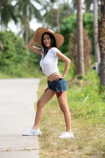 Busty Asian Babe in a Bikini Oils Her Hairy Bush Outdoors