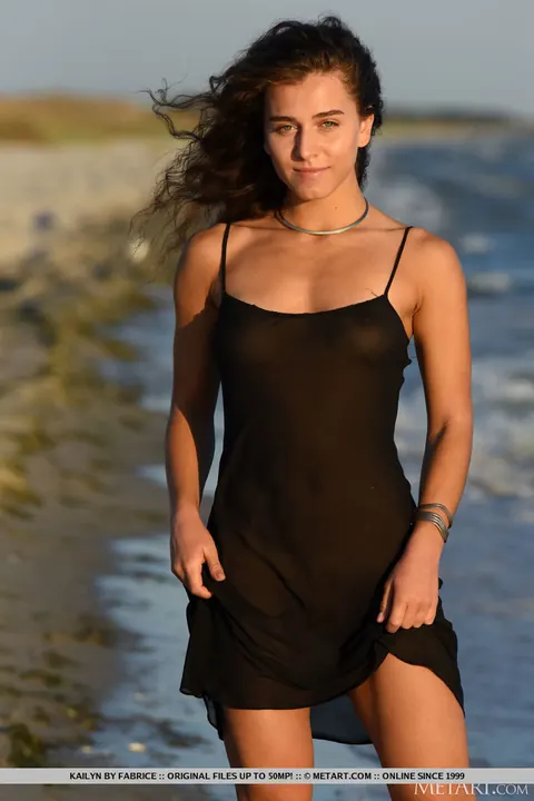 Brunette Strips Out of Her Skirt on the Beach – photo 2 of 18