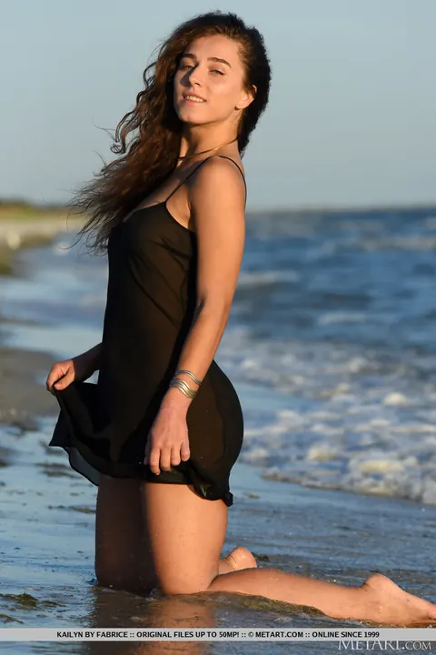 Brunette Strips Out of Her Skirt on the Beach – photo 3 of 18
