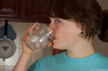 Chubby Short-Haired Woman Fingers Her Hairy Pussy in the Kitchen