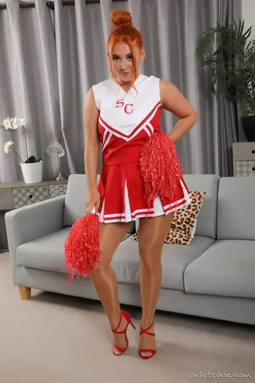 Busty Woman in a Skirt and Lingerie Spreads Her Pussy in Heels