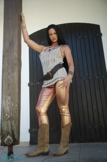 Tori W – Latina Brunette with Big Enhanced Tits Poses in Gold Yoga Pants and Boots