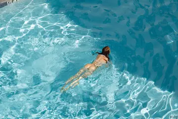 Petite Redhead Strips Out of Her Bikini and Spreads at the Pool