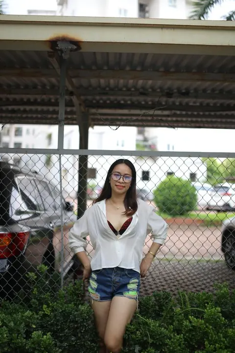 Asian Brunette Poses in Shorts and Glasses Outdoors – photo 7 of 21