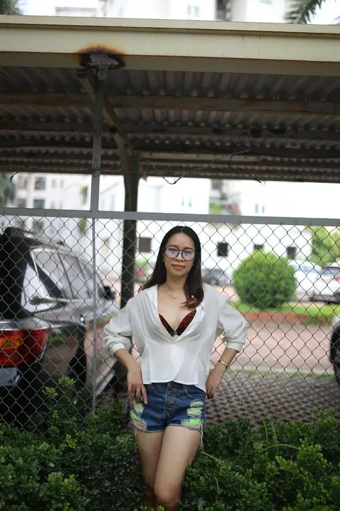 Asian Brunette Poses in Shorts and Glasses Outdoors – photo 6 of 21