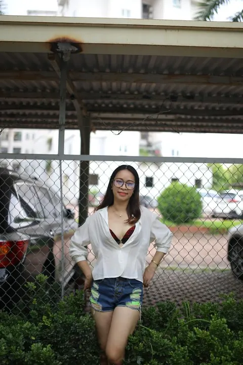 Asian Brunette Poses in Shorts and Glasses Outdoors – photo 8 of 21