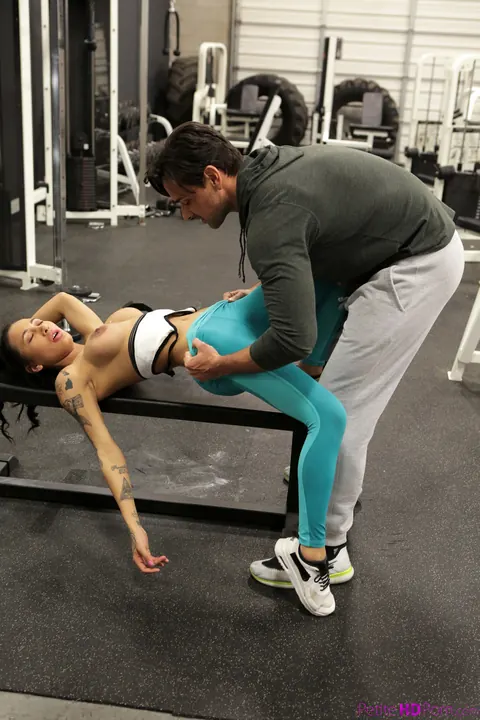 Amia Moretti: Slim Curly Brunette with Big Tits Sucks Trainer and Rides Him at the Gym – photo 7 of 17