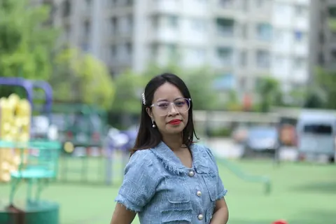 Petite Asian Woman in Glasses Poses Outdoors – photo 2 of 21