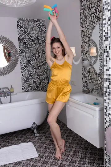 Slim Amateur Brunette Bares Her Hairy Pussy in the Bathroom
