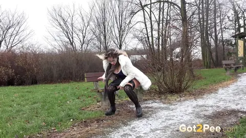 Woman in Shorts and Glasses Squats to Piss on a Path – photo 4 of 15