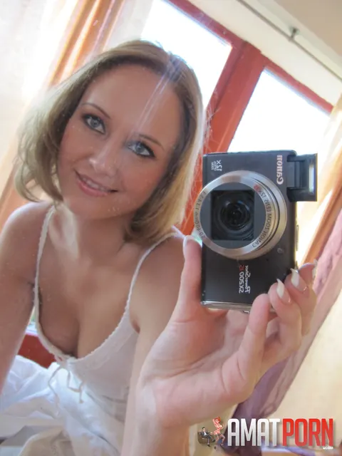 Redhead in a Skirt Strips for a Mirror Selfie – photo 4 of 15