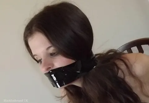 Brunette in Pantyhose and Skirt Restrained Before a Mirror – photo 14 of 16