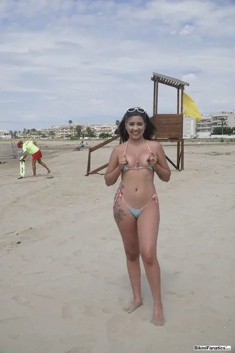 Brunette Unties Her Bikini Top on the Beach – photo 11 of 12
