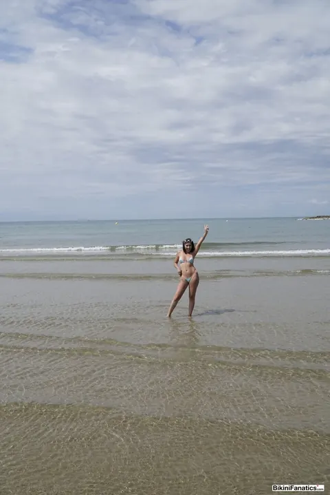 Brunette Unties Her Bikini Top on the Beach – photo 6 of 12
