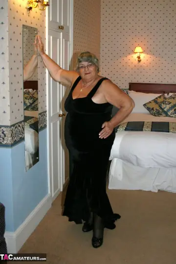 BBW Brunette Poses in Stockings and Glasses