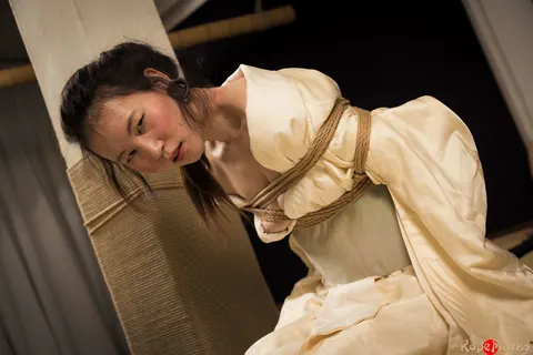 Asian Brunette Restrained with Rope in Shibari Session – photo 11 of 16