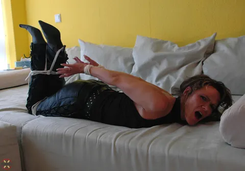 Hogtied Woman in Leather and High Heels Left on the Sofa – photo 3 of 16