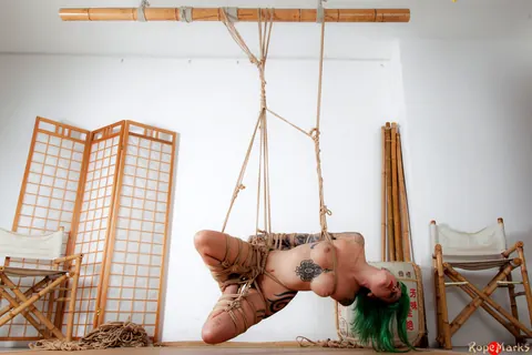 Busty Tattooed Woman Suspended Naked in Rope Bondage – photo 4 of 16