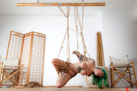 Busty Tattooed Woman Suspended Naked in Rope Bondage – photo 5 of 16
