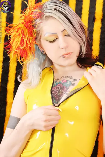Blonde Strips Out of Latex to Show Her Tattoos and Piercings