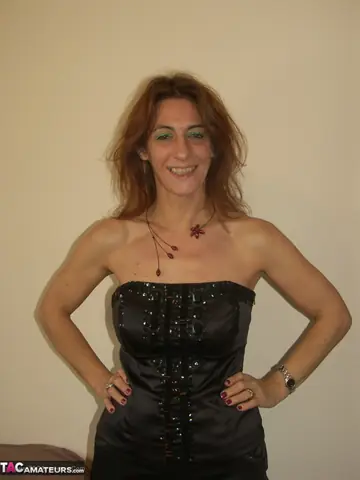 Mature Redhead Strips Off Her Panties and Fingers Her Pussy